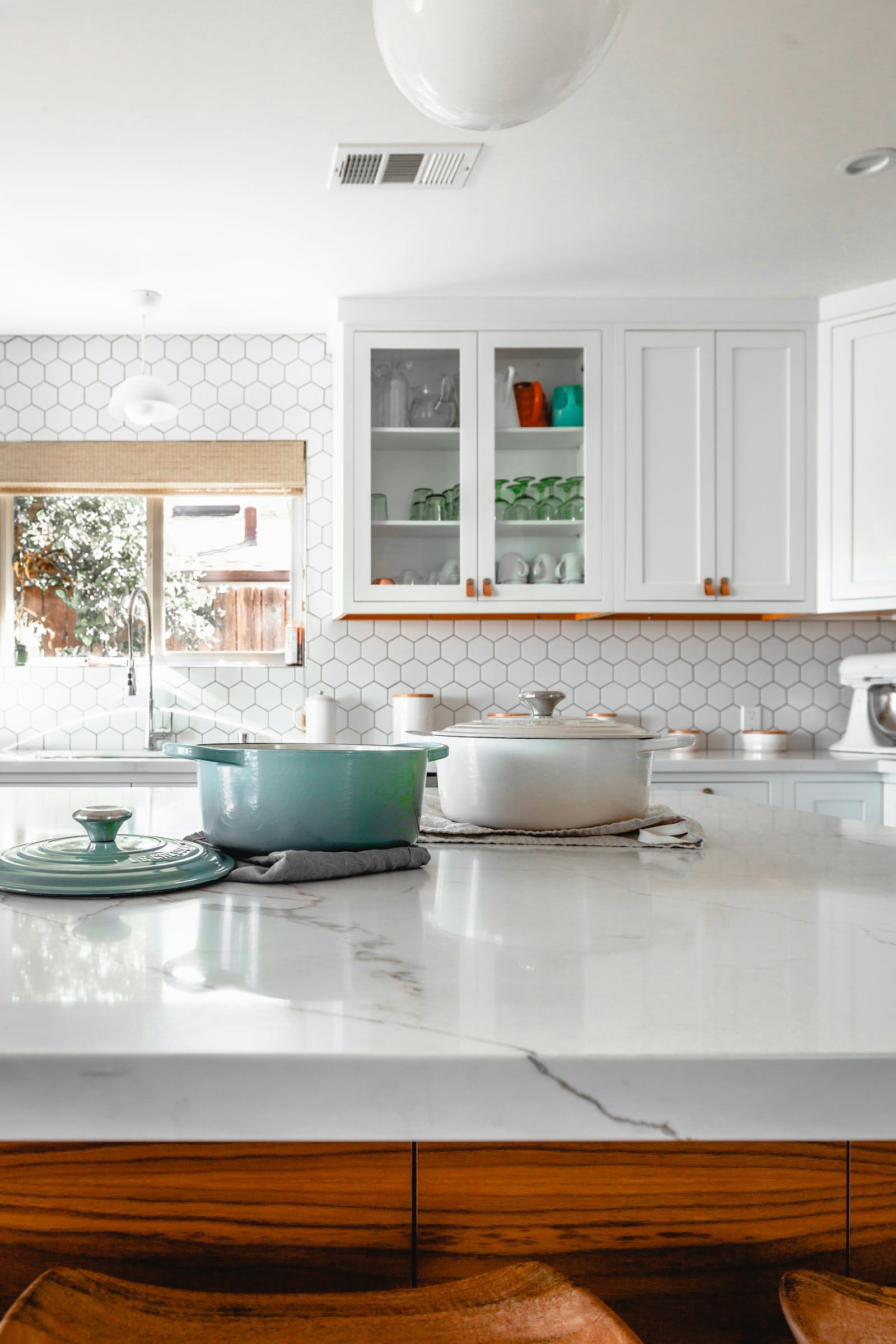 A quiet kitchen counter with bowls and warm daylight