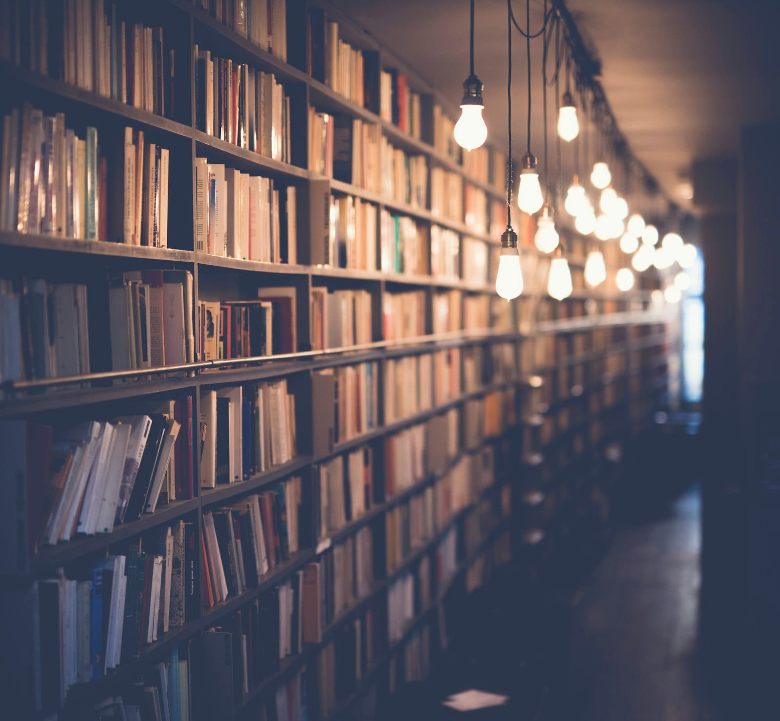 Rows of old books in warm indoor light